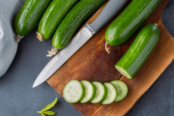 Fresh cucumber slices chopped on black  stone table