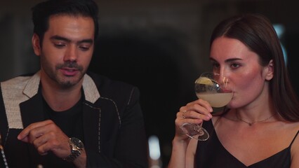 Beautiful woman zipping Margarita cocktail savoring sour tasty drink beside smart couple or friend at luxurious bar creating happiness moment in meeting at vibrant nightclub on Friday night. Vinosity.