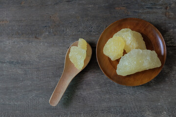 Rock sugar on wood spoon over old wood background.Sweet food.
