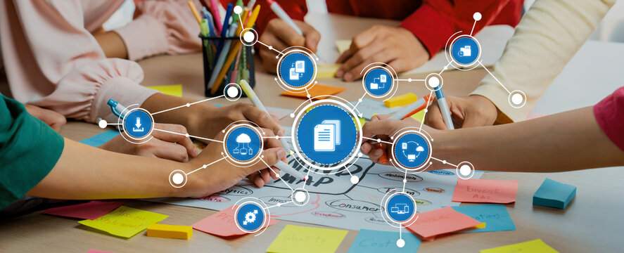 Creative business team brainstorming about marketing strategy and business plan by using mind mapping. Startup team work together to write down on paper. Focus on hand. Closeup. Variegated. Amity - Powered by Adobe