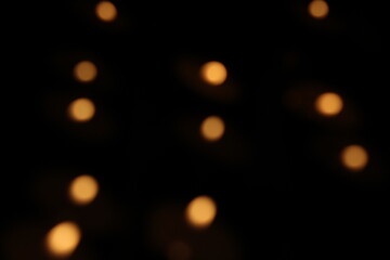 Christmas lights in bokeh. Outside in December. Red and fire orange bokeh on a black background, bokeh abstract background, modern technological abstract background. Orange Christmas background, Xmas 