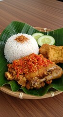 Spicy Ayam Geprek with Sambal on Banana Leaf Plate