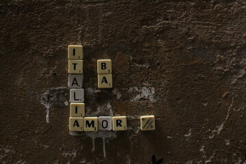 Italia Amor text on a wall created by small bricks with letters. Italia and Amor text concept 