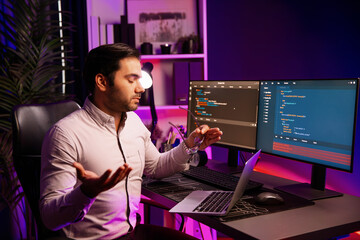 Serious smart IT developer meeting via application team record on laptop to solve problem in error...