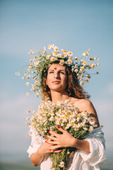 Daisy Woman Wreath: Summer light illuminates smiling lady holding flowers under blue sky...