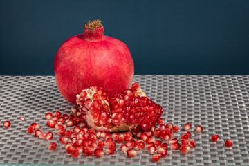 Fresh pomegranate fruit and grains on the table