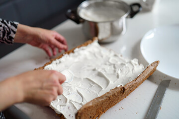 Baking a layered dessert with whipped cream on a countertop in a modern kitchen setting