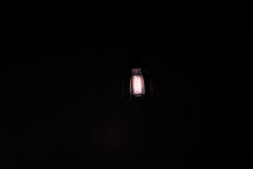Glowing lightbulb seen in dark room