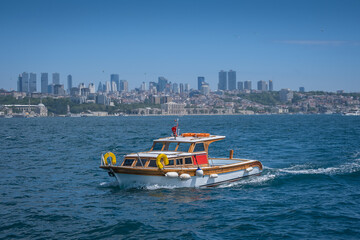 Obraz premium Wooden, pleasure and fishing boat. Bosphorus and Istanbul in the background. istanbul, turkey.