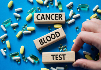 Cancer Blood Test symbol. Concept word Cancer Blood Test on wooden blocks. Doctor Hand. Beautiful...
