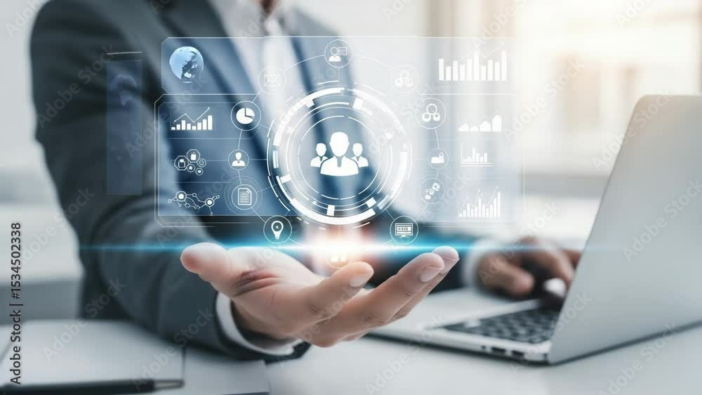 Poster businessman holding digital interface with team icon and data charts over open hand near laptop