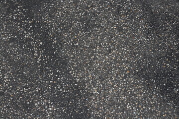 Grainy asphalt textured abstract background. Pavement asphalt with stones and rocks background