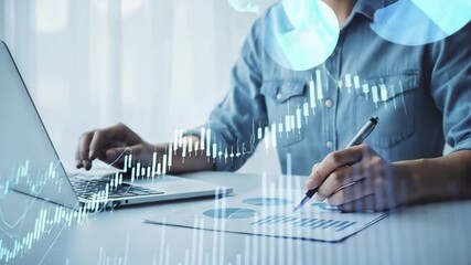 Person analyzing stock market data on laptop and paper with pen in a bright office setting - Powered by Adobe