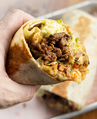 Hand Holding a Burrito 