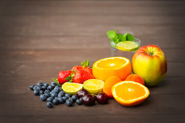 Rustic Still Life with Fresh Fruits and Glass Jar on Wooden Background