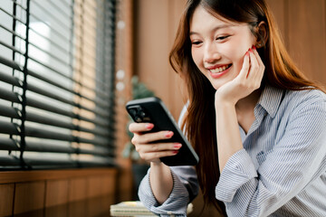 Beautiful smiling young woman using smartphone, playing social media, shopping online, video...