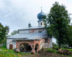 Nikolo-Medvedsky Monastery in Novaya Ladoga. It is located next to the Cathedral of the Nativity of the Blessed Virgin Mary. Tourists are exploring the attraction.