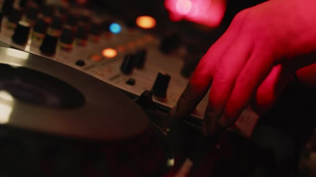 Dj mixing music on analog audio mixer board