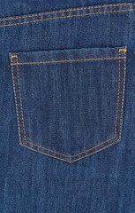 Close up of classic blue jeans textile. Detail of denim pants pocket.