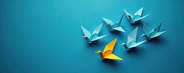 Origami birds fly on blue background. Yellow origami bird leads flock of blue ones. Motivation concept design for business. Leadership, success and hope symbolize business growth.