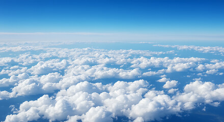 Beautiful aerial view of a serene blue sky filled with fluffy white clouds during daytime.