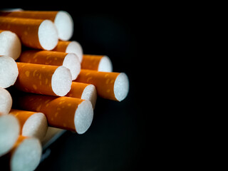 close up cigarette filters on dark background