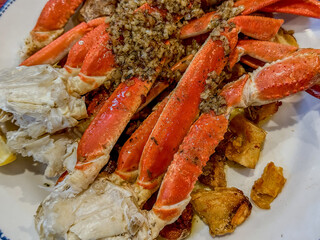 Steamed Snow Crab Legs Topped With Chopped Garlic And Butter