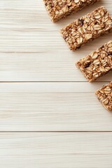 Several gluten free desserts on a light wooden table. Delicious low carb snacks. Sweet baked square bars with nuts and oats.