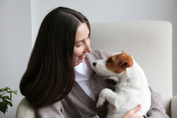 Young woman relaxing at home with her dog. Copy space, background.