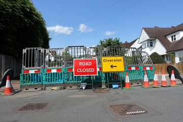 Due to roadworks, the road is closed, and a diversion sign is displayed in front of a barricaded section