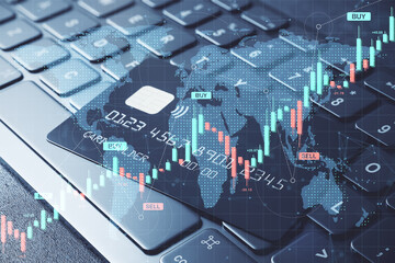 Digital credit card on keyboard with forex trading candlestick chart and global financial data overlay in abstract fintech background concept.