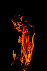 Fototapeta premium Close-up Shot of a Bonfire Flame in the Dark – Captivating Fire Texture and Burning Wood with Intense Heat, Perfect for Background