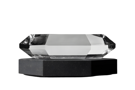 A glass octagon-shaped object on a black pedestal