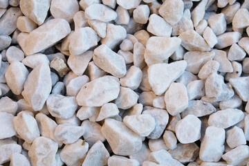 Marble chips, stone for landscape design, top view background.