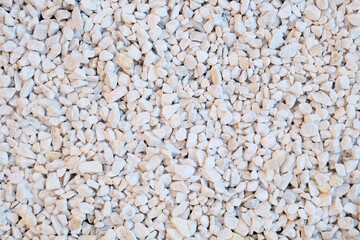 Marble chips, stone for landscape design, top view background.