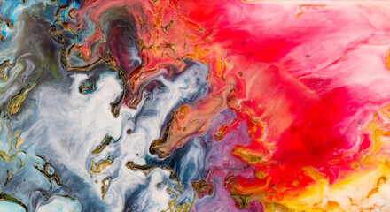 Abstract fluid acrylic paint swirls in vibrant red blue white and gold color palette