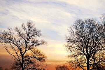 The colors in the sky transition from warm oranges to cool blues, creating a beautiful blend of...