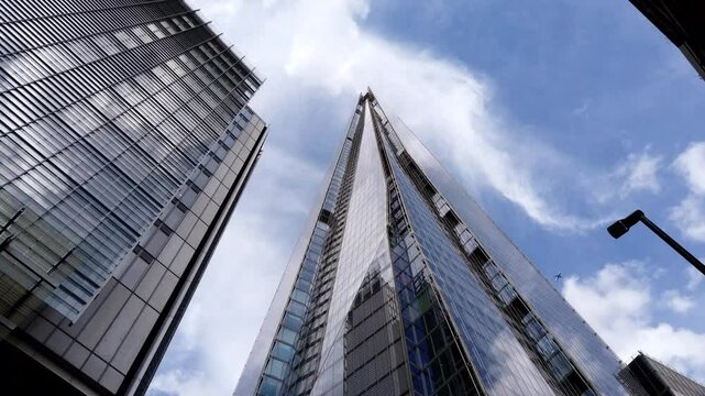 Motion-lapse featuring the Shard building amidst the cityscape. Urban beauty. London, England, UK skyscraper against a dramatic cloudy sky