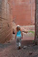 Woman hiking in a red volcanic sand and rocks deposit at Lanzarote, Spain. Travel lifestyle concept