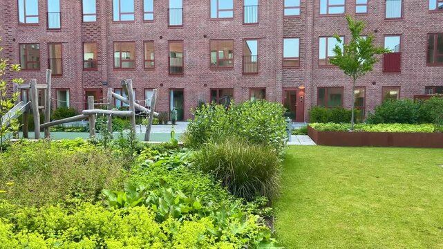 Herning, Denmark - June 12, 2025: Modern architecture apartments in Denmark summer days. Modern block of flats. A large building with a courtyard in the middle. Danish architecture design. Houses 