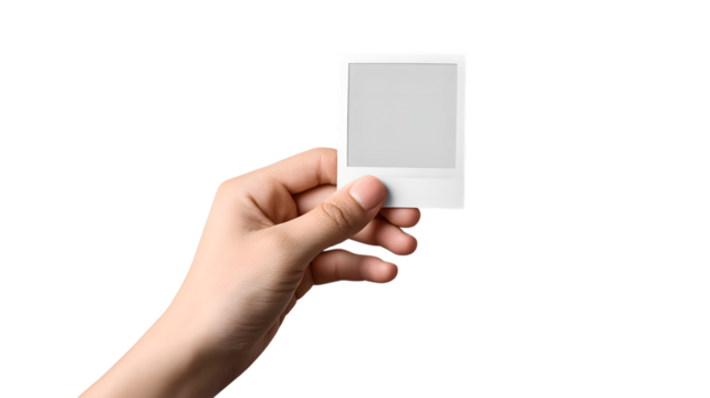 Hand holding an instant photo frame with copy space against a isolated on white transparent background evoking nostalgia and memory, perfect for mockups.