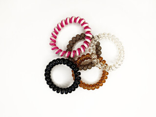 Colorful assortment of hair ties displayed on a white background showcasing various styles and materials
