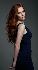 Fototapeta premium Elegant fashion portrait of a woman in a navy dress studio setting modern aesthetic side profile