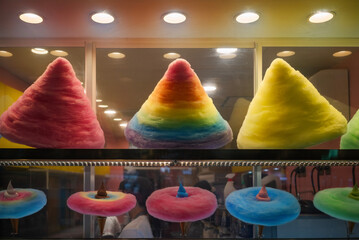 A display of ice cream cones surrounded by rainbow-colored cotton candy at a Japanese candy store in Odaiba, known for its rainbow bridge, which is a reference to the colors that delight children.
