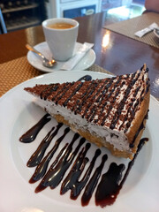 Chocolate cream pie with whipped topping and chocolate drizzle served with espresso