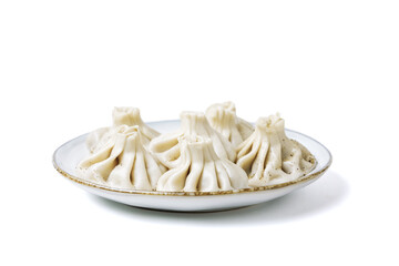 Plate with traditional georgian khinkali (dumplings) isolated on white background. Side view, copy space.