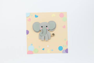 Flat lay of playful elephant craft with colorful paper pieces, perfect for stationery brands, kids workshop visuals, preschool educators, toy packaging, learning platforms,