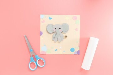 Flat lay of paper elephant and craft supplies for children art class or preschool DIY lessons, perfect for education business, craft kit sellers, toy brands,