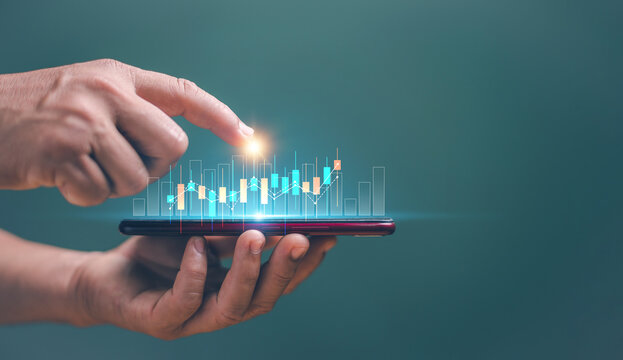 Online stock trading and algorithmic concept with digital financial candlestick. Businessman trader investor analyst using smartphone analytics for financial market analysis. Invest in trading.