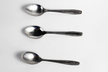 Bunch of iron spoons isolated on white background.interior home appliances